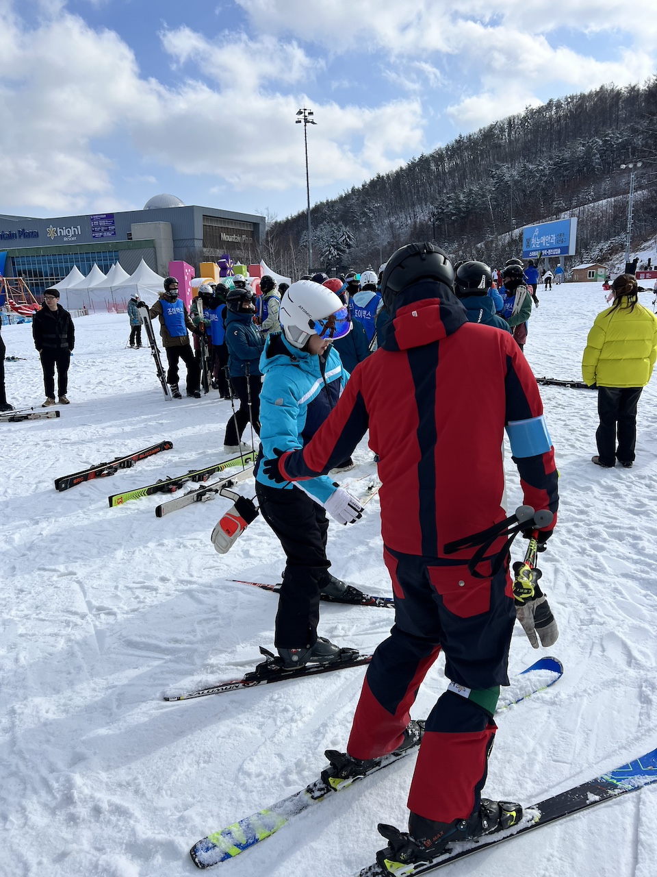 A ski instructor helps my wife as she prepares for her first ever ski lesson at High 1 Resort.