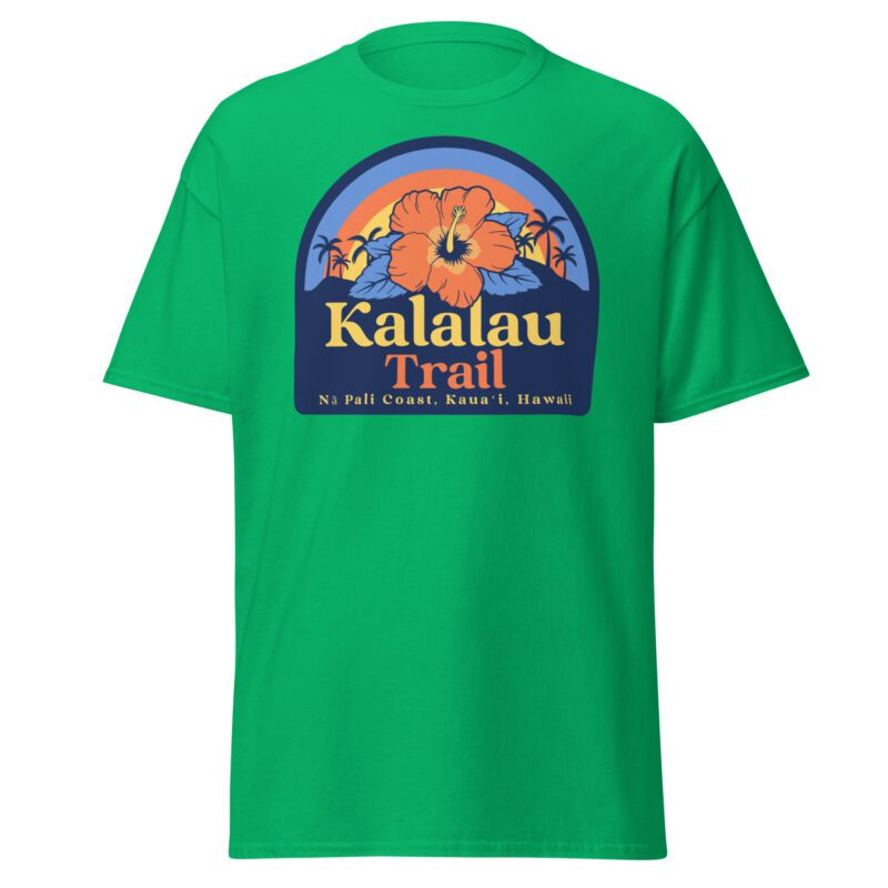 Irish green t-shirt featuring bold text "Kalalau Trail" with smaller text "Na Pali Coast, Kauai, Hawaii." The design includes a tropical flower centered in front of an island landscape with palm trees and a rainbow in the background.