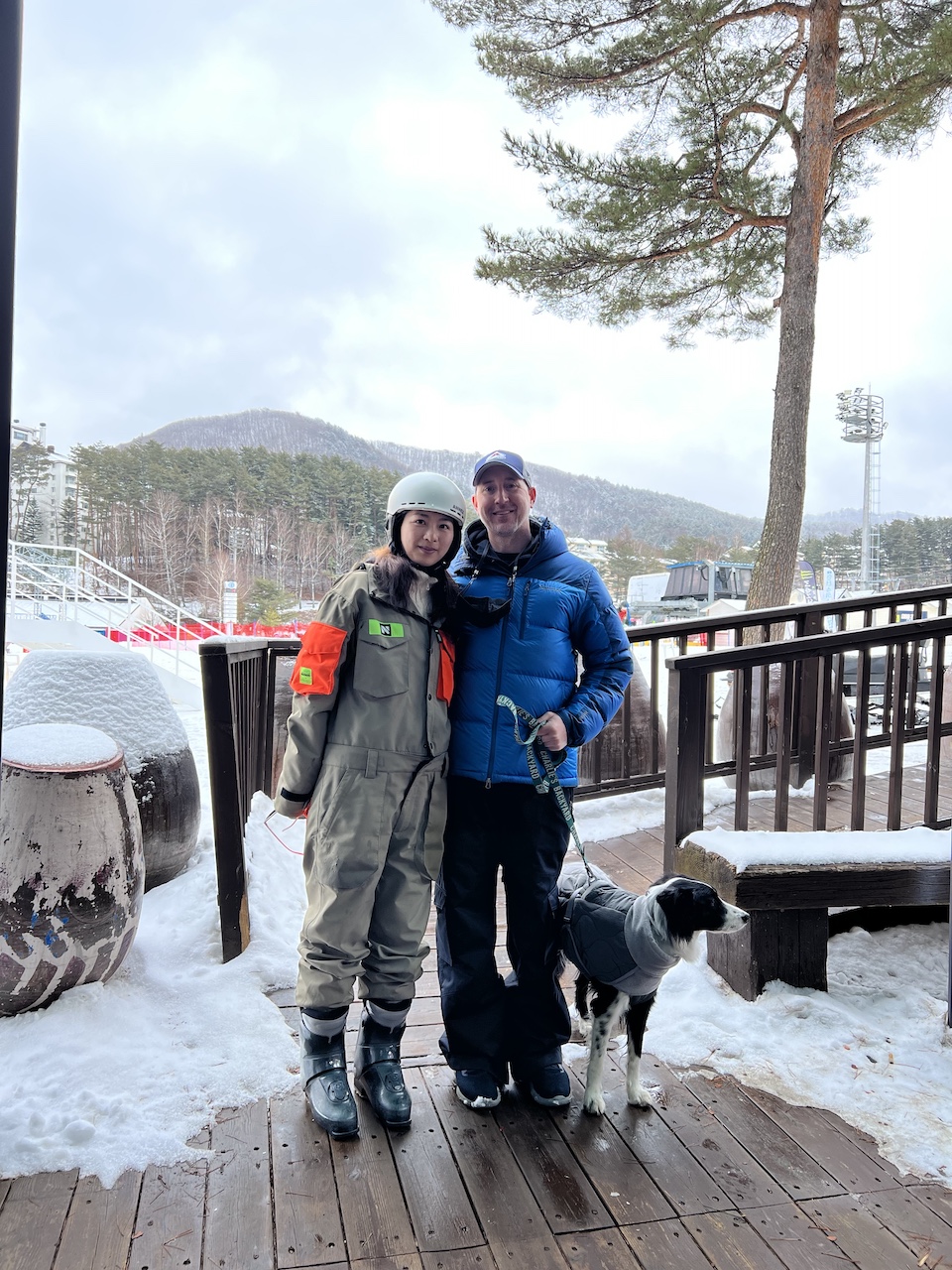 A family and their dog pose for a photo on the deck outside of Dragon Plaza at Yongpyong Resort in South Korea. 