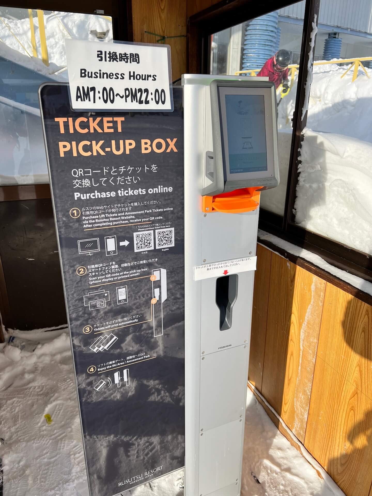 Touchscreen lift ticket kiosk at Rusutsu Resort with snow outside the window
