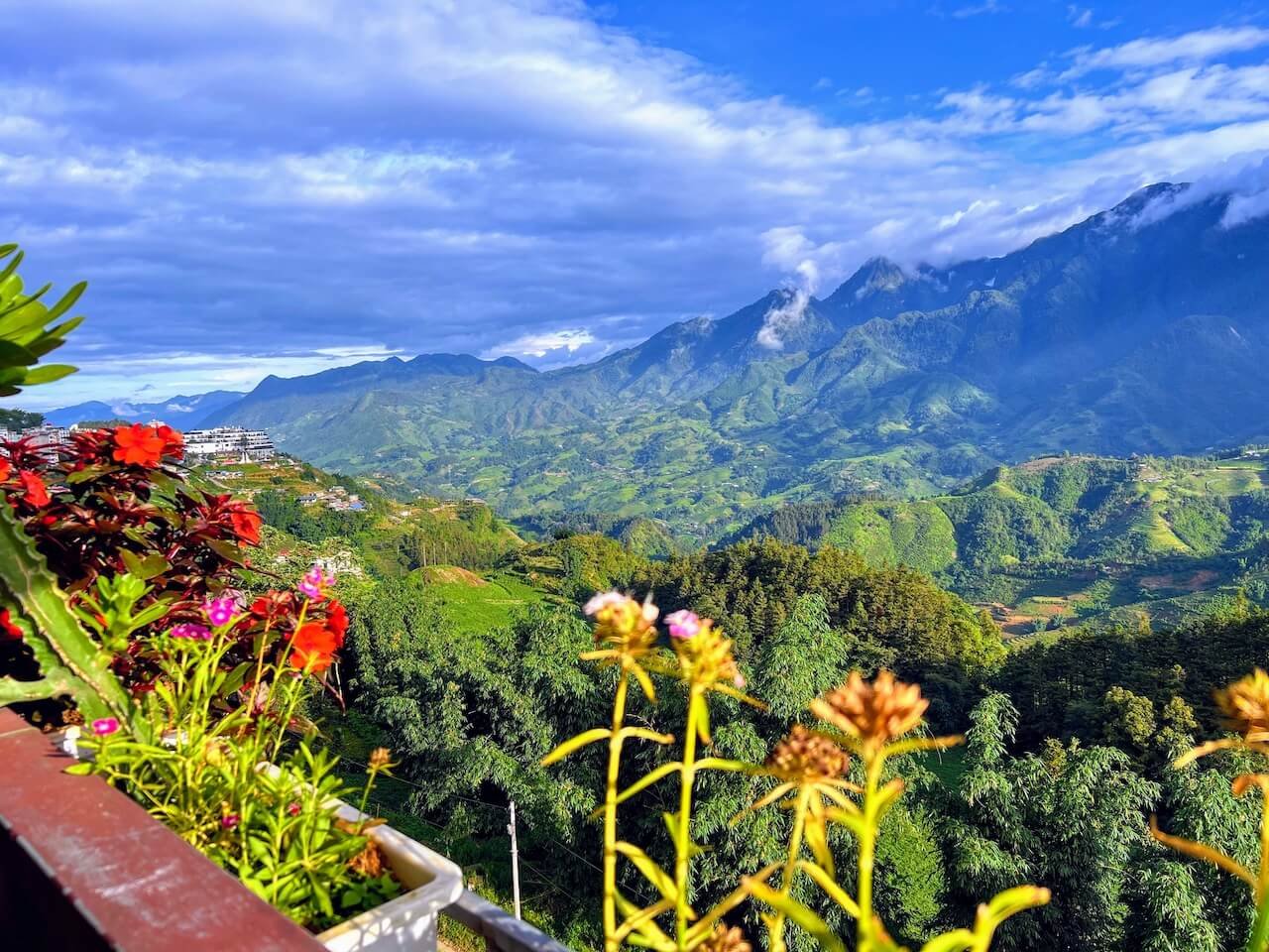 Scenic mountain view over the lush green hills of Sa Pa, Vietnam, seen from the balcony of White Cloud Cafe & Restaurant.