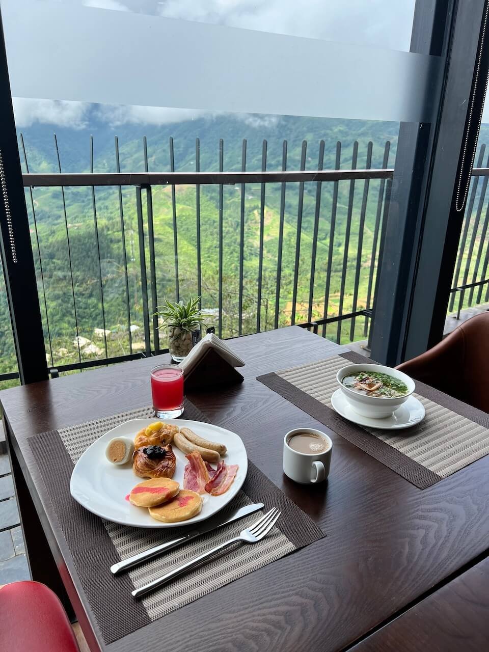 A combination of Western-style and traditional Vietnamese breakfast at Pao’s in Sa Pa, featuring eggs, a crispy baguette, and a cup of coffee served on a wooden table.