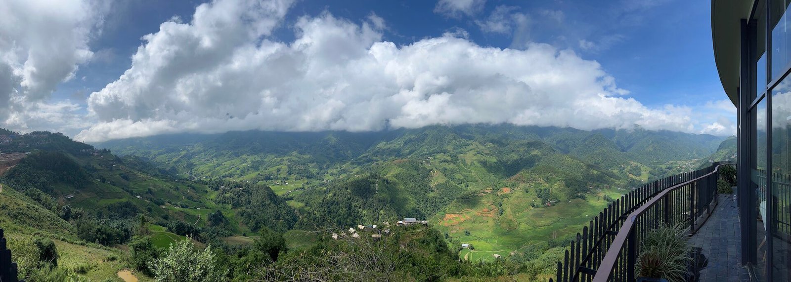 A stunning morning view from the terrace at Pao’s Sapa Leisure Hotel, overlooking misty mountains and lush green hills while enjoying breakfast.