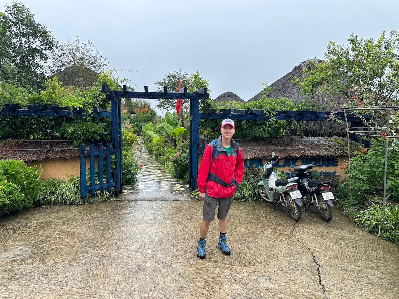 Traveler standing in front of Sapa Clay House, a key waypoint on the trekking route from Sapa to Lao Chai in Vietnam.