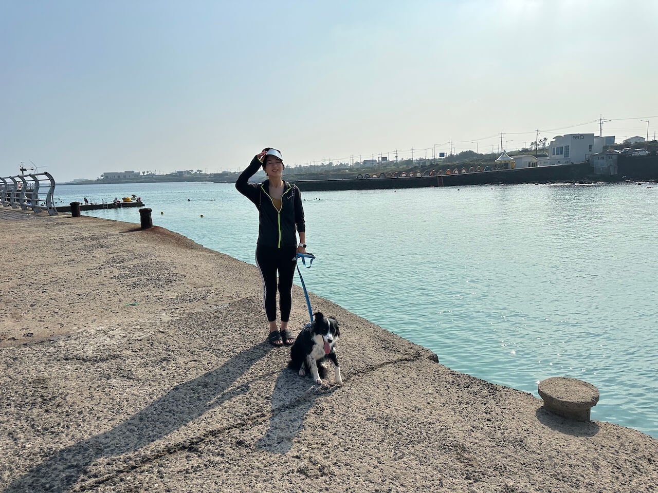 Panpo Port on Jeju Island with calm turquoise water and a concrete shoreline, a quiet stop along a Jeju road trip