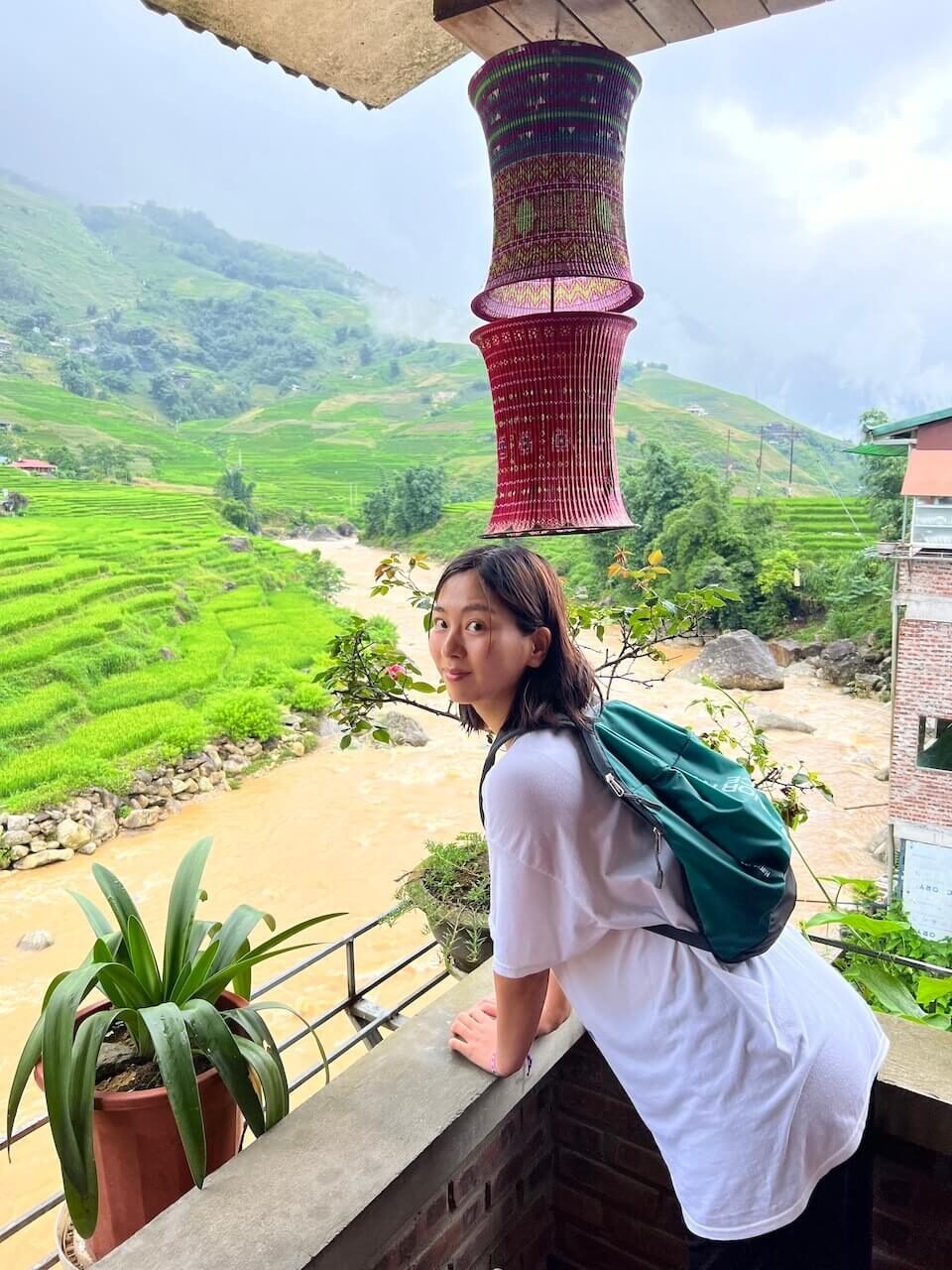 3 Days in Sapa Without a Guide – A Realistic DIY Itinerary for Independent Travelers 9 Traveler enjoying the view from a café in Lao Chai Village, overlooking the Muong Hoa Valley in Sapa, Vietnam
