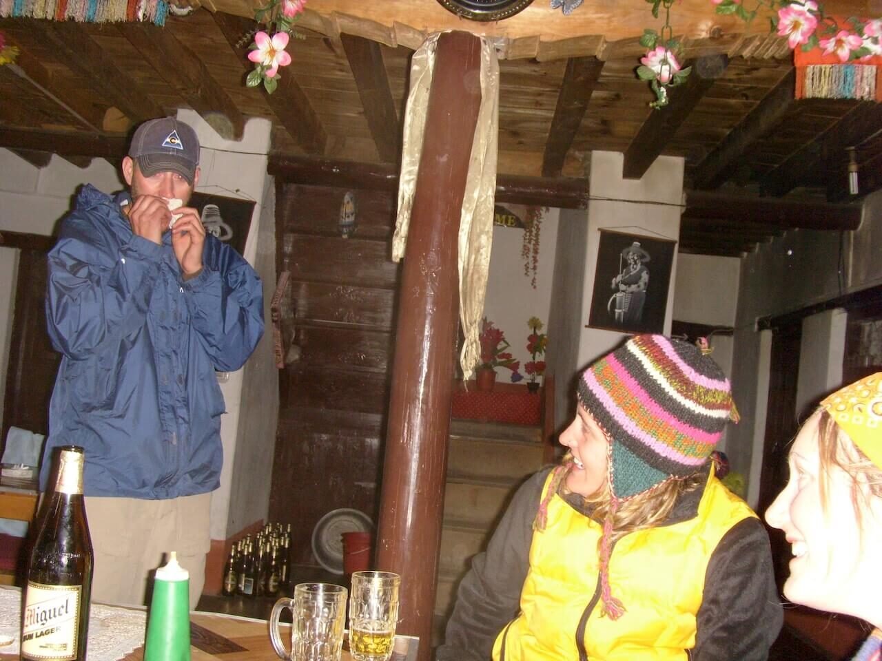 Annapurna Circuit vs Everest Base Camp: How to Choose the Right Nepal Trek 15 Author reacting dramatically after taking a chili sauce shot in a teahouse at Muktinath following a Thorong La Pass crossing