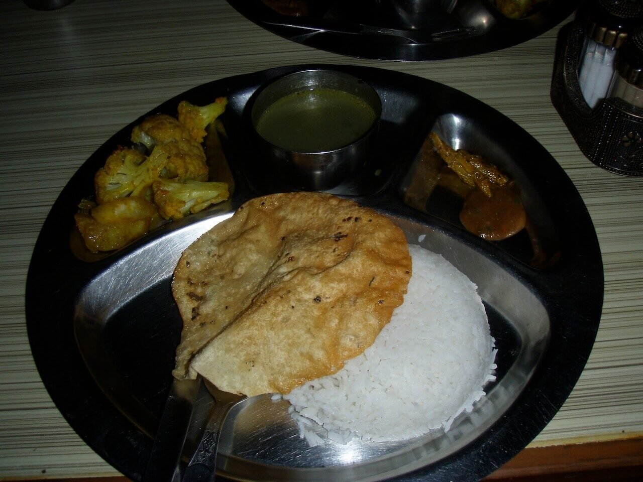 Annapurna Circuit vs Everest Base Camp: How to Choose the Right Nepal Trek 8 Traditional dal bhat meal served on a metal tray at a teahouse on the Annapurna Circuit, Nepal