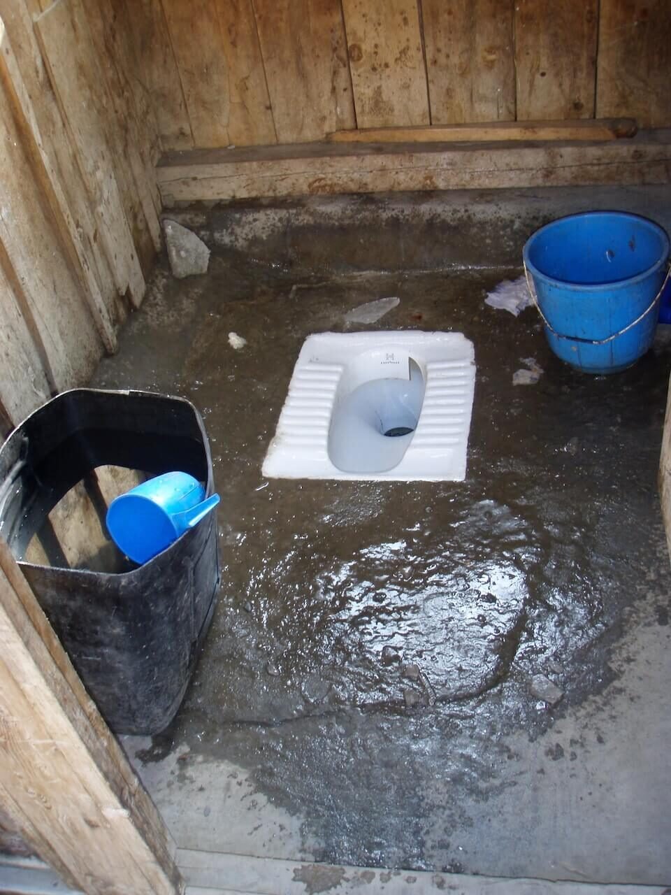 Annapurna Circuit vs Everest Base Camp: How to Choose the Right Nepal Trek 9 Frozen-over squat toilet inside a wooden stall at one of the highest teahouse stops on the Annapurna Circuit