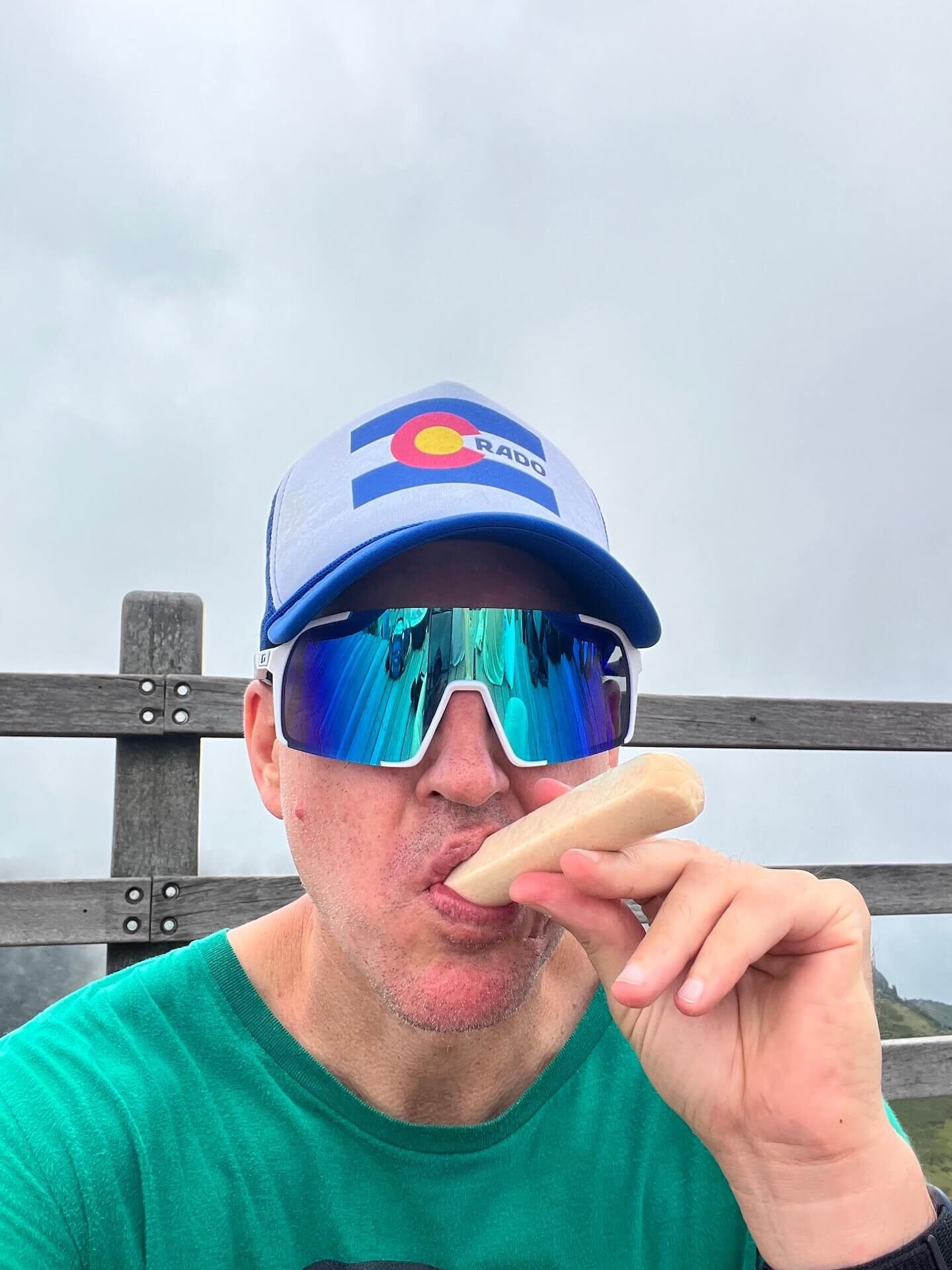 Why Climbing Hallasan in Summer Nearly Broke Me (And What I’d Do Differently) 13 Hiker eating a Korean chicken sausage snack at the summit of Hallasan after a long hike