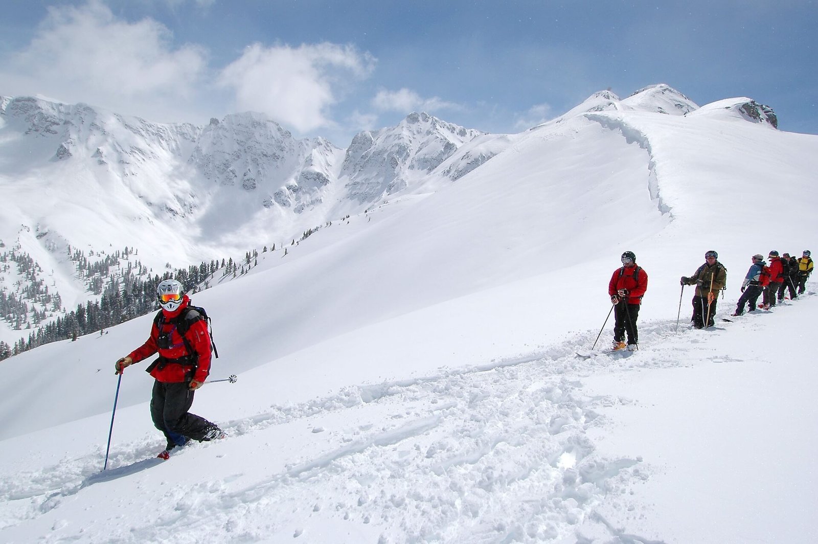 Group of ski journalists and guides preparing for a descent in Silverton, Colorado