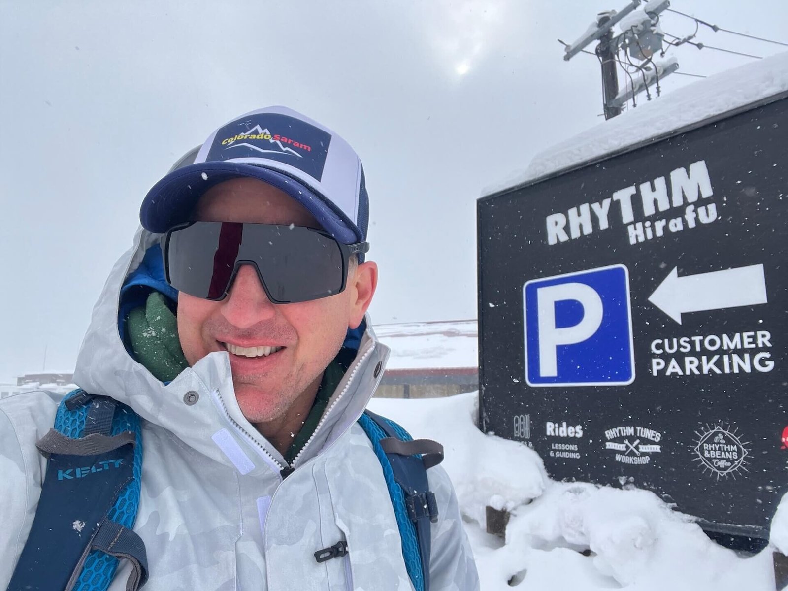 Planning a Hokkaido Ski Trip? Here’s How Niseko and Rusutsu Compare in 2025 3 Rhythm Japan Hirafu ski rental shop in Niseko, with snow falling in the parking lot.