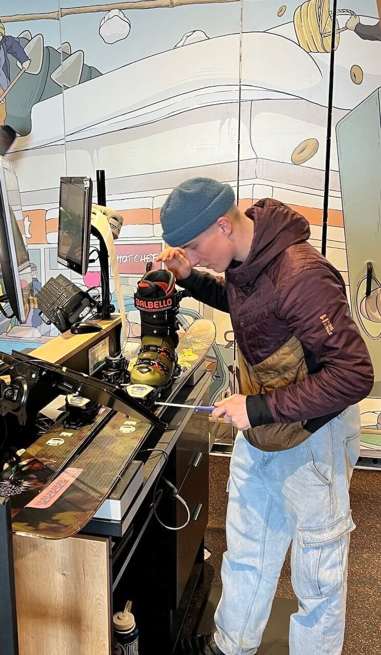 The Perfect 5–7 Day Hokkaido Ski Itinerary (2025 Guide) 7 Ski technician adjusting bindings on K2 Reckoner skis at Rhythm Japan rental shop in Niseko