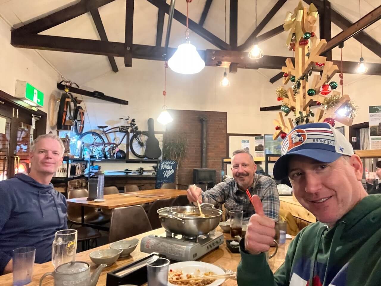 The Perfect 5–7 Day Hokkaido Ski Itinerary (2025 Guide) 13 Travelers enjoying shabu-shabu dinner inside Rookie’s Kitchen restaurant in Niseko, Japan