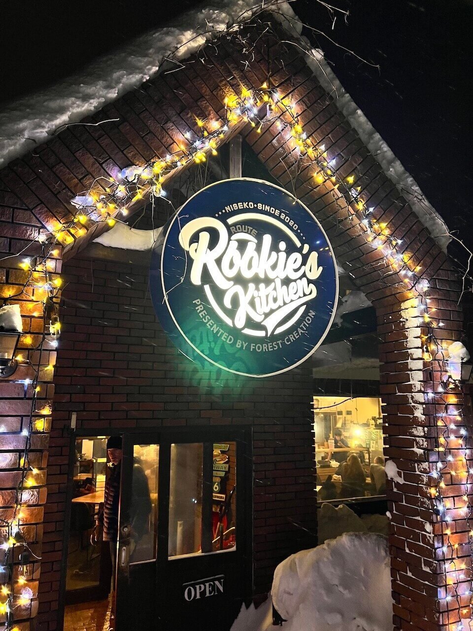 The Perfect 5–7 Day Hokkaido Ski Itinerary (2025 Guide) 12 Exterior of Rookie’s Kitchen restaurant in Niseko with winter lights and snow on the roof