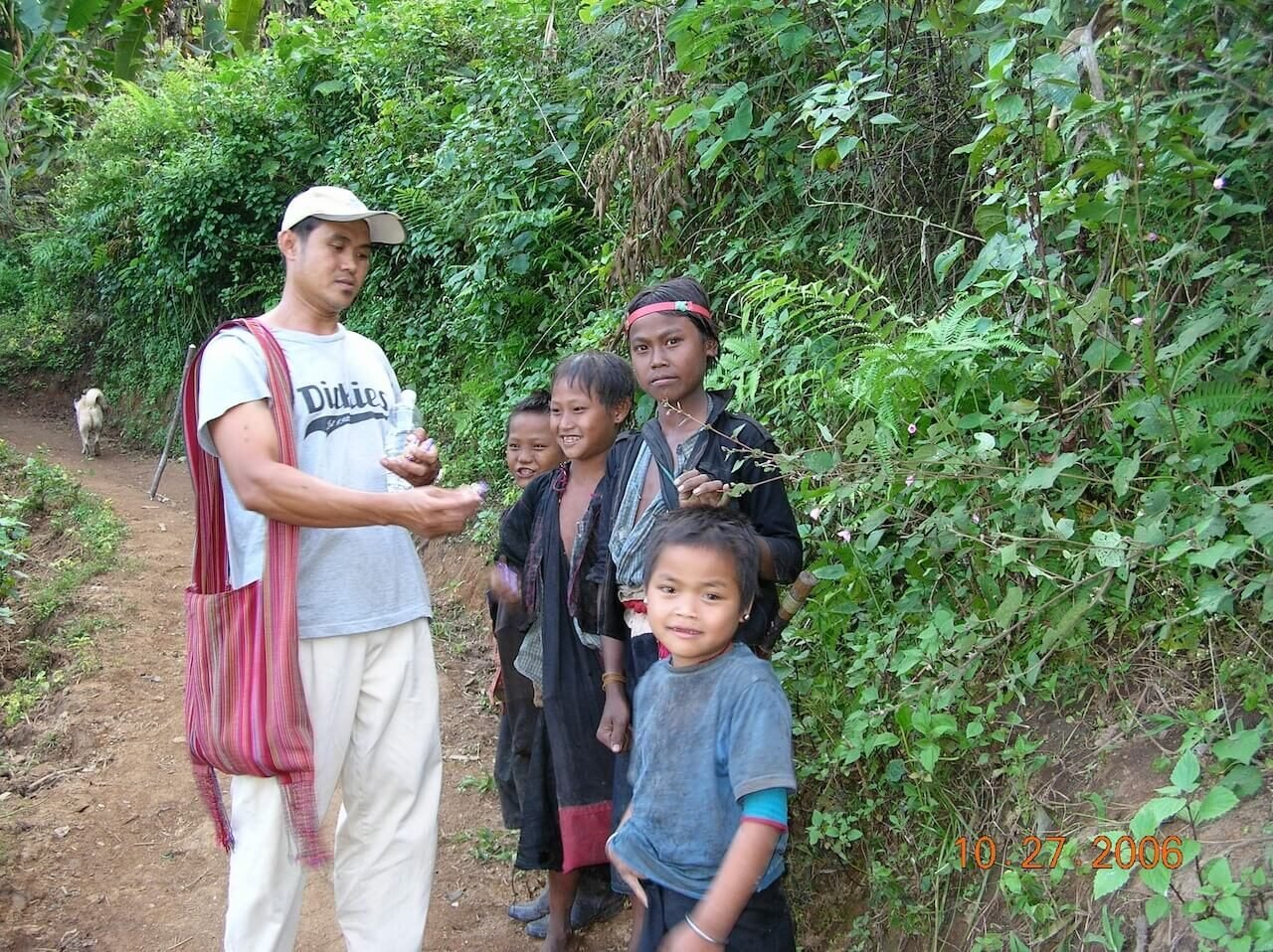 Local guide introducing the author to hill tribe children near Kengtung, Myanmar, during a remote trek through the country’s northeast.