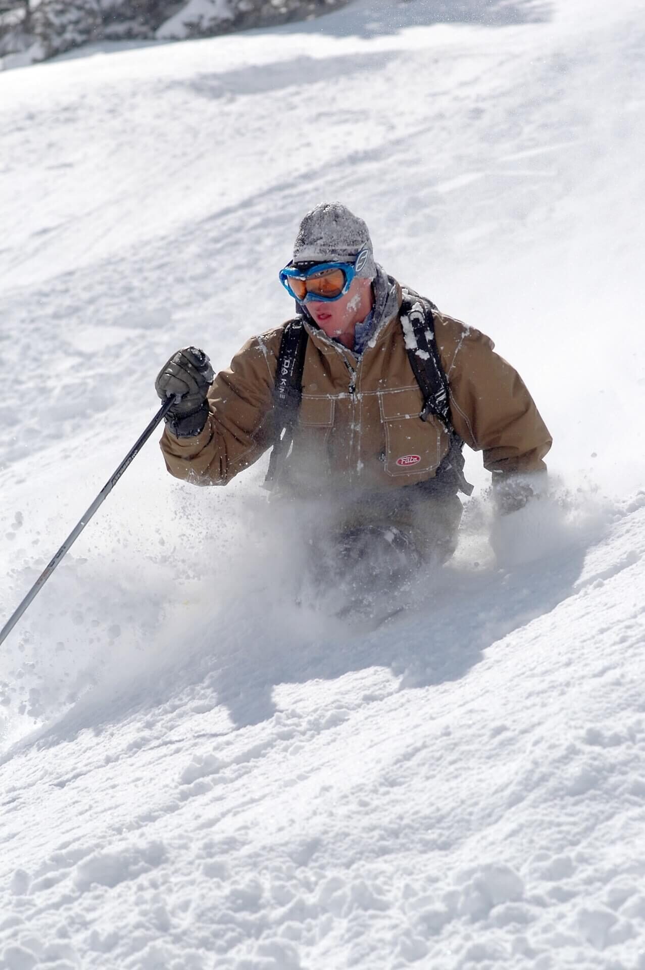 Skier carving through deep powder at Silverton Mountain, Colorado
