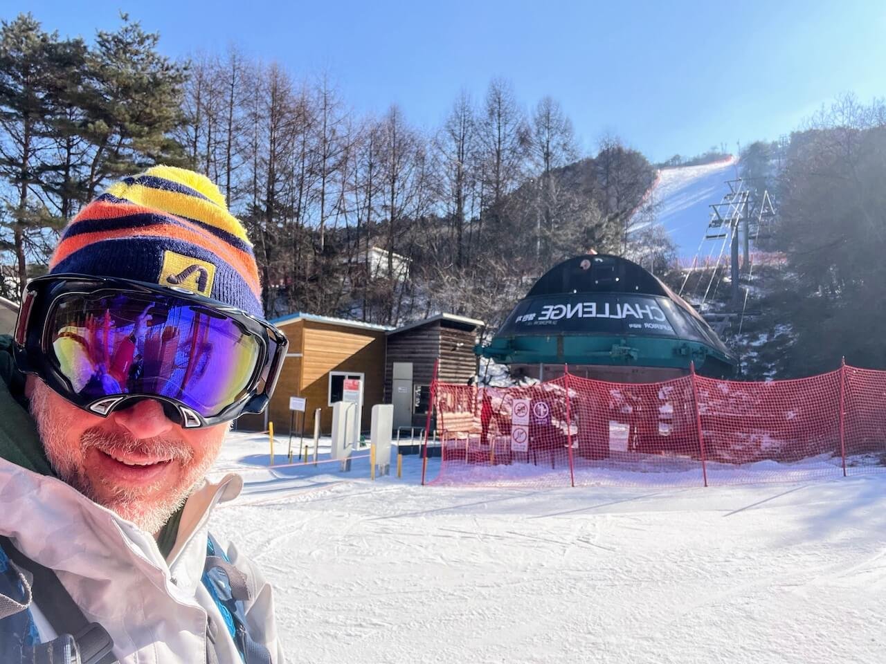 Skier standing at the base of the Challenge lift at Welli Hilli with no lift line visible