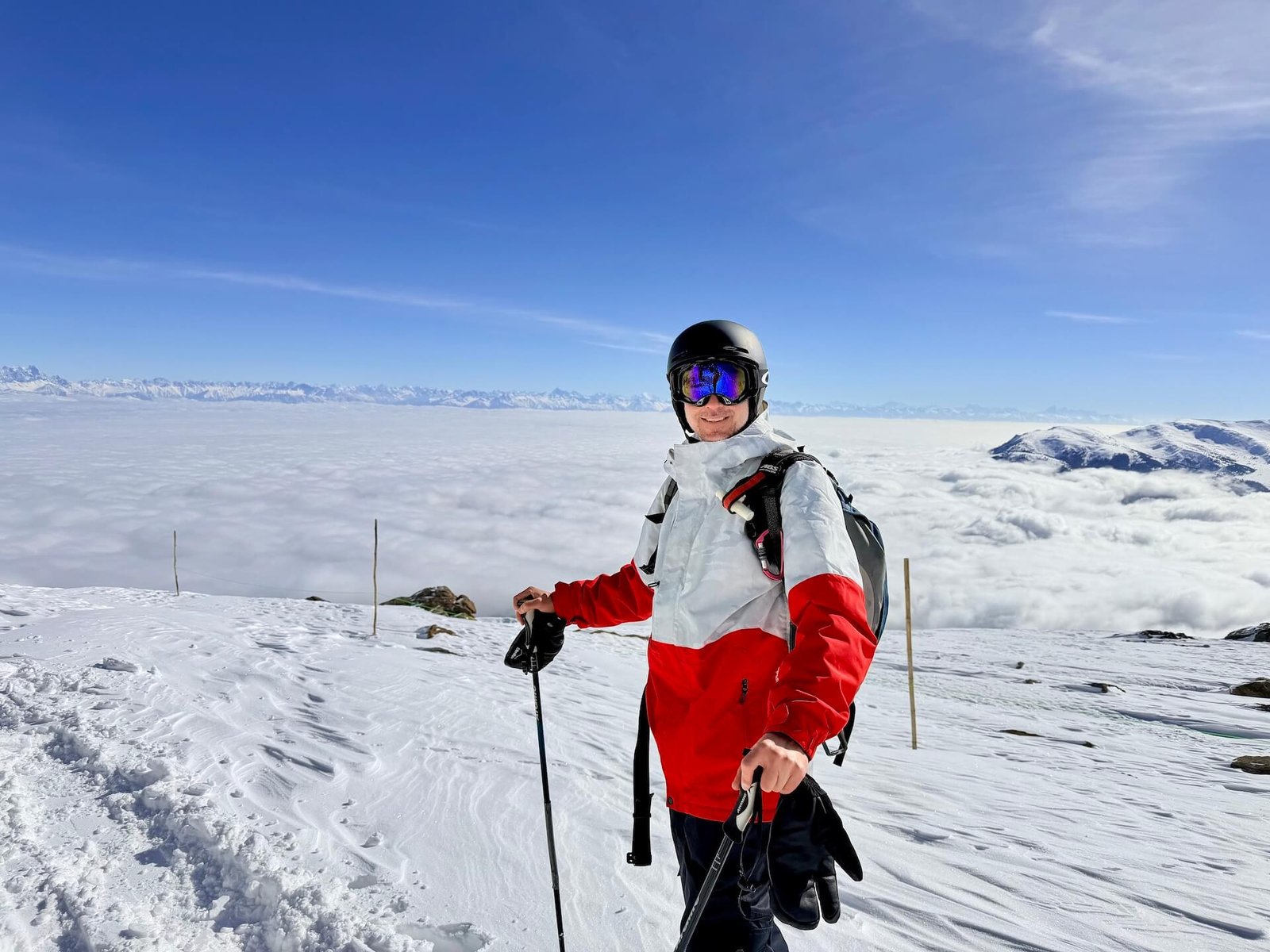 Do You Need a Guide to Ski Gulmarg? 3 Skier standing at the top of Phase 2 in Gulmarg with Himalayan peaks above the cloud layer
