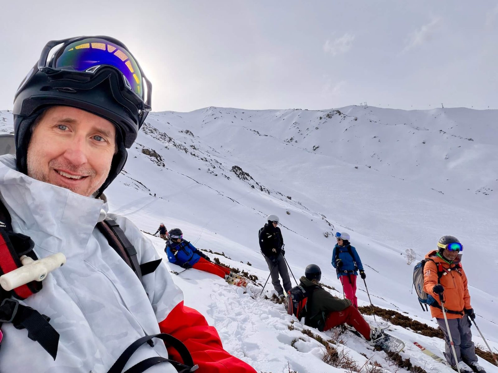 Do You Need a Guide to Ski Gulmarg? 5 Skiers and snowboarders traversing ridgeline terrain above Phase 2 in Gulmarg Kashmir